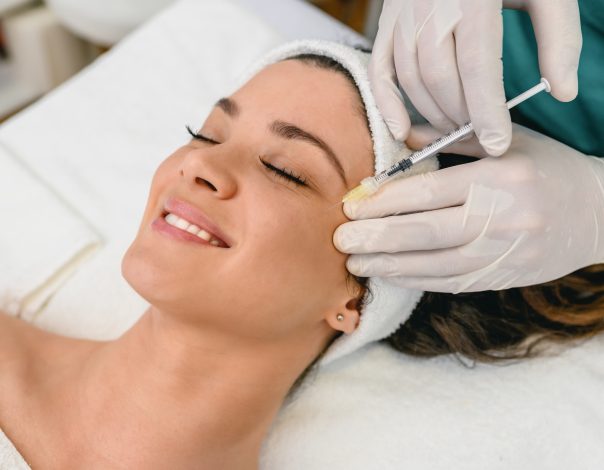 Woman getting injection in face.